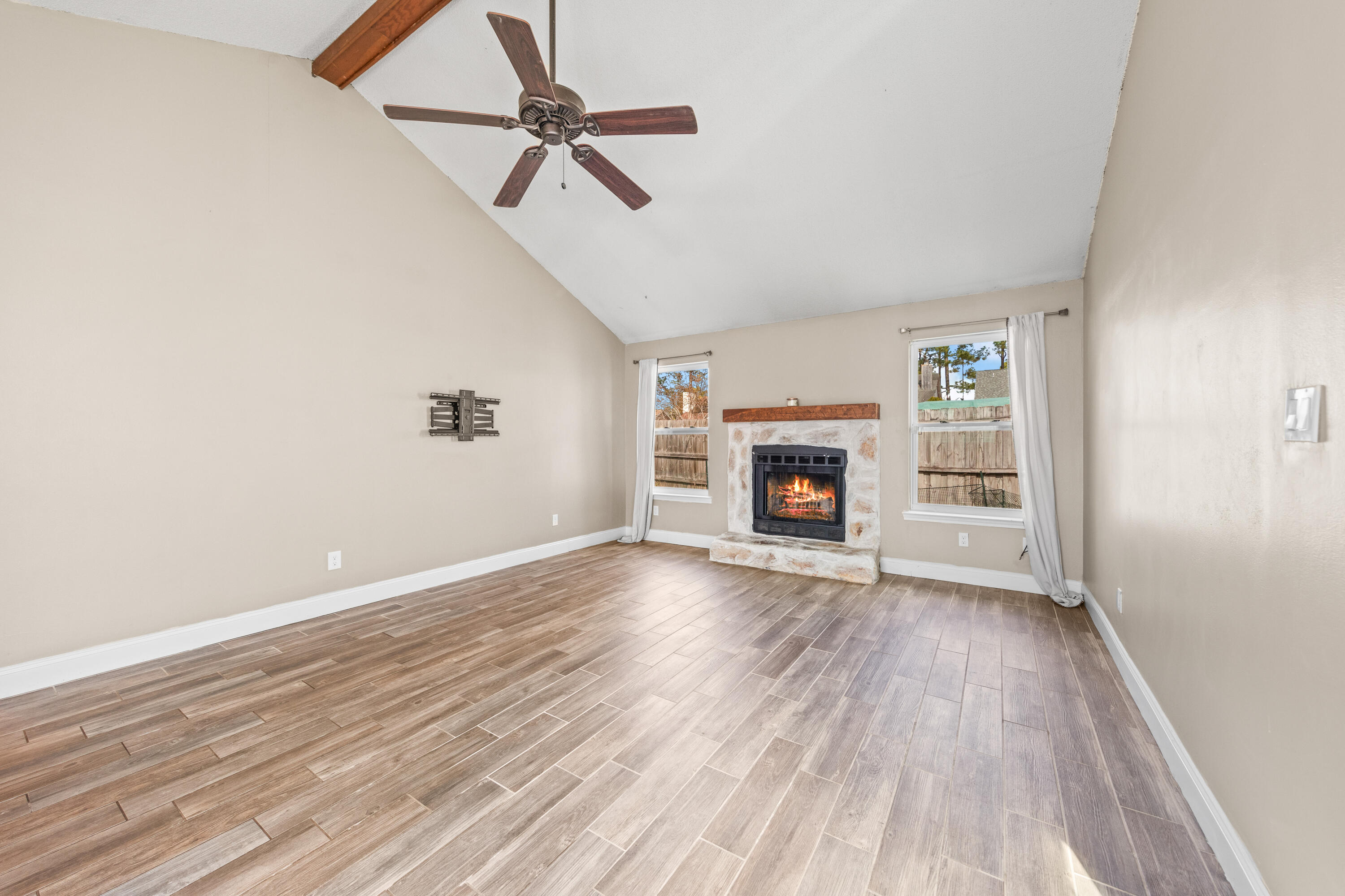 1833 Hunters Path Fort Walton Beach, FL 32547 - Photo 9 of 43 a view of empty room with fireplace and wooden floor