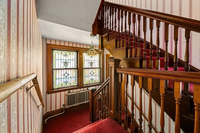 a view of entryway with wooden floor and stairs