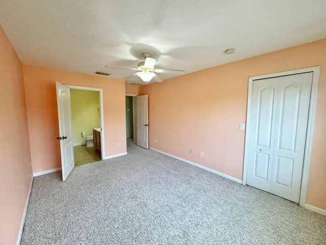 a view of a livingroom with a chandelier fan