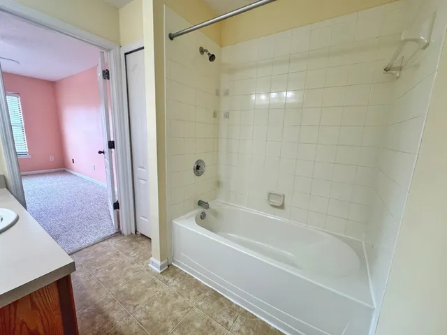 a spacious bathroom with a bathtub and a shower