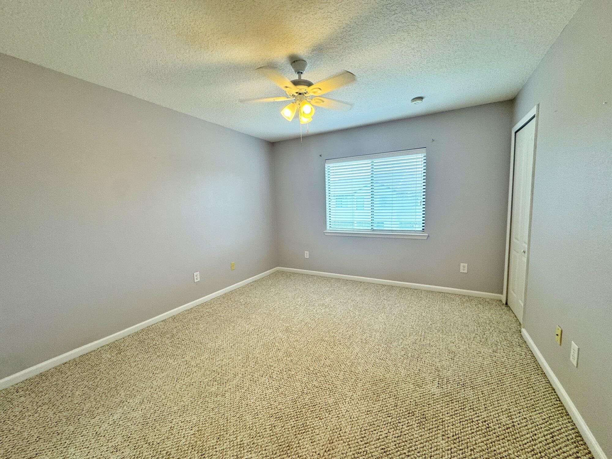 237 Syrah Way St. Augustine, FL 32084 - Photo 19 of 26 an empty room with a window and a ceiling fan
