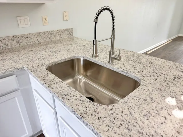 a kitchen with a sink and a mirror