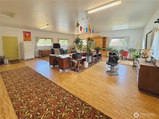 a living room with furniture window and wooden floor