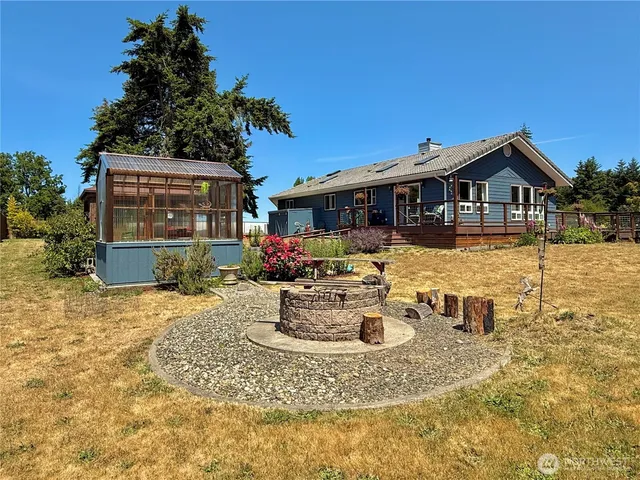 a view of a house with backyard water fountain and sitting area