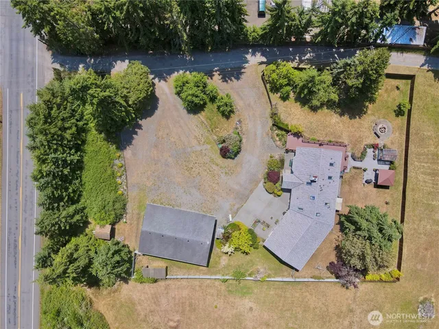 an aerial view of a house with garden space and lake view