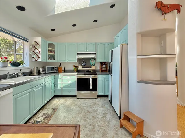a kitchen with stainless steel appliances granite countertop a refrigerator and a sink