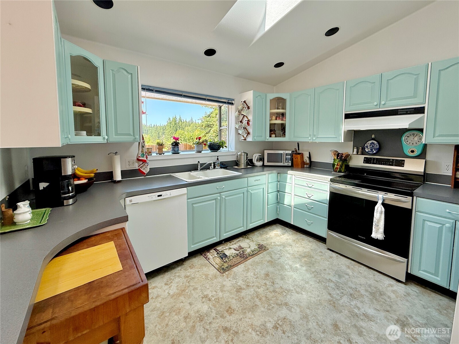 10 Davenhill Lane Sequim, WA 98382 - Photo 8 of 39 a kitchen with a sink a stove and cabinets