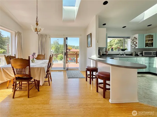 a dining room with furniture and wooden floor