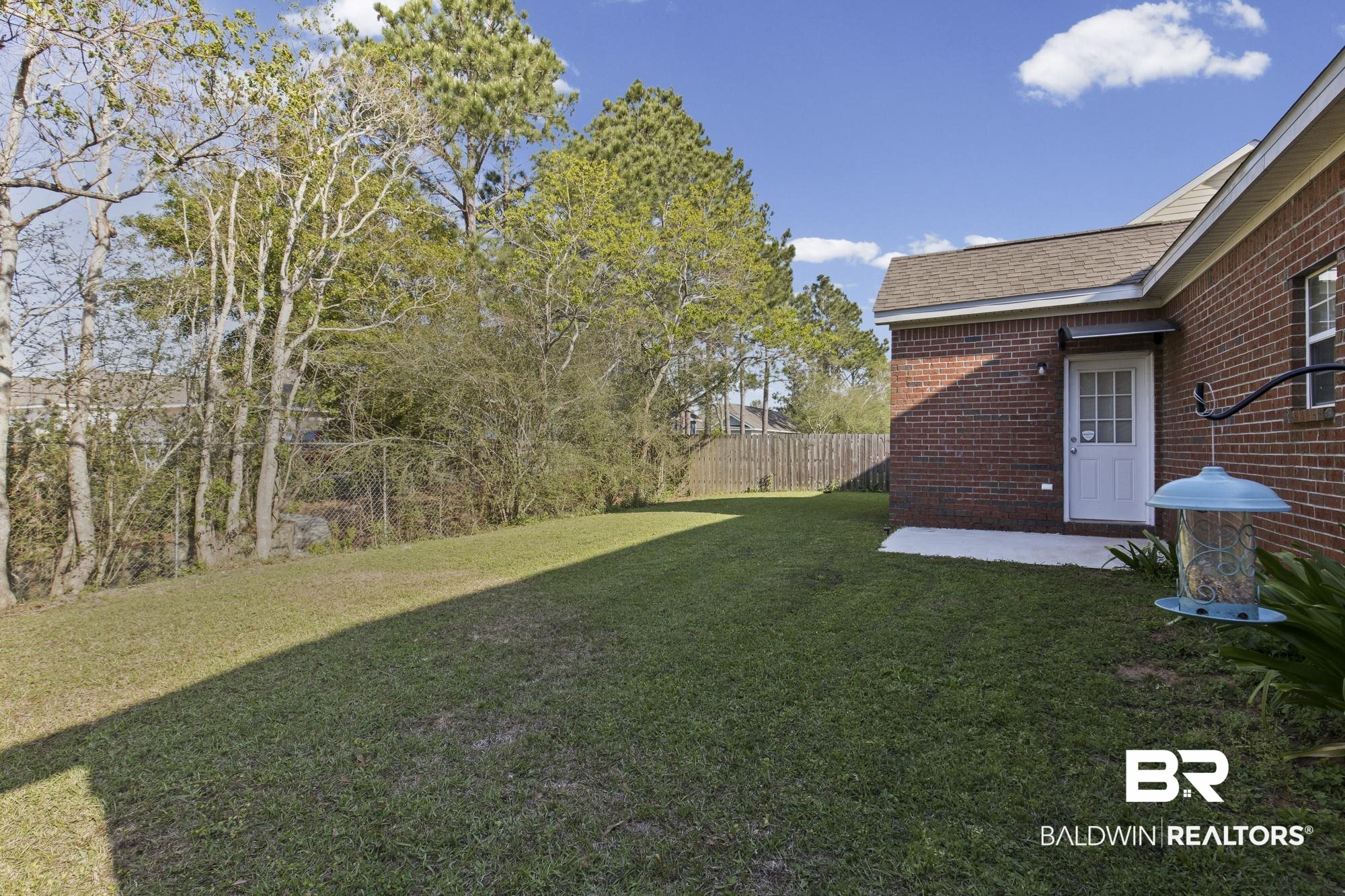1153 Sloane Cove Foley, AL 36535 - Photo 23 of 25 Fenced yard featuring a patio