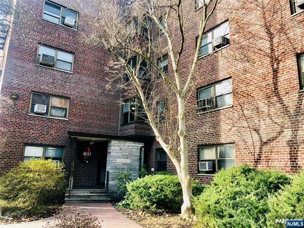 a front view of a house with brick walls