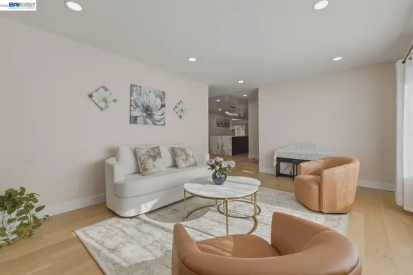 a living room with furniture and a potted plant