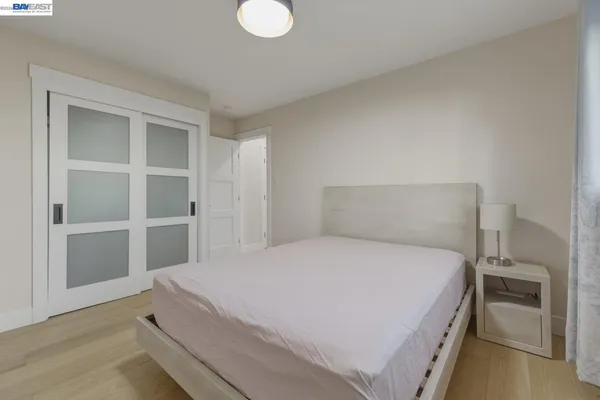 an empty room with windows and closet