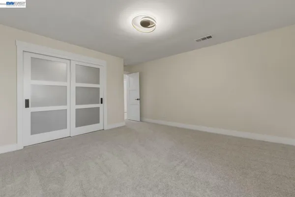 a bedroom with a bed and cabinets