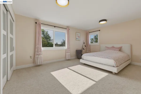 a large spacious bathroom with a double vanity sink a mirror and a bathtub