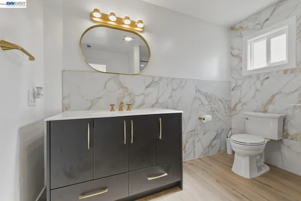 a large bathroom with a large tub sink and mirror