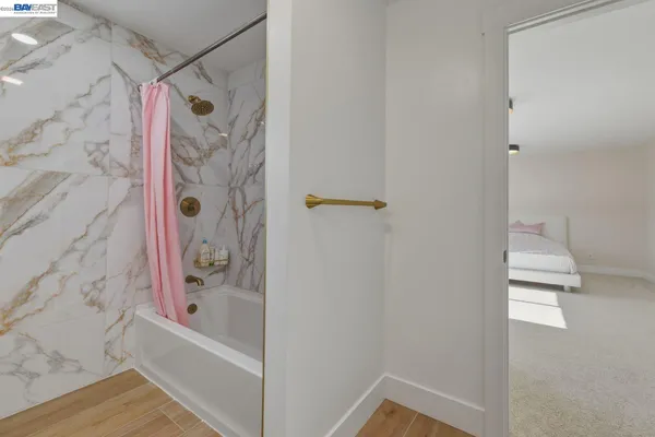 a spacious bedroom with a bed and a chandelier