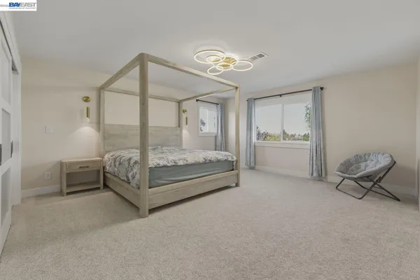 a white bath tub sitting in a bathroom next to a window