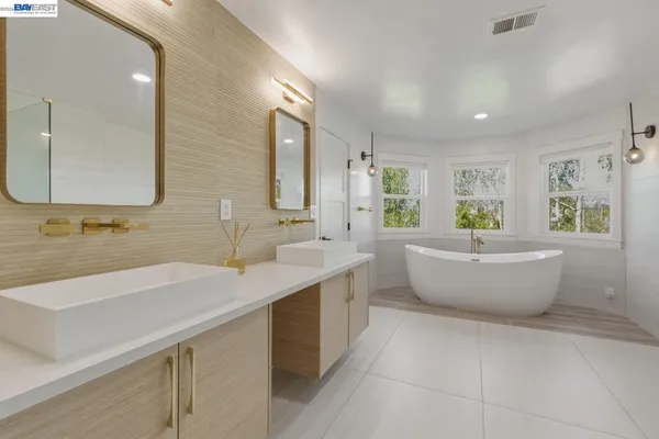 a bathroom with a double vanity sink mirror and