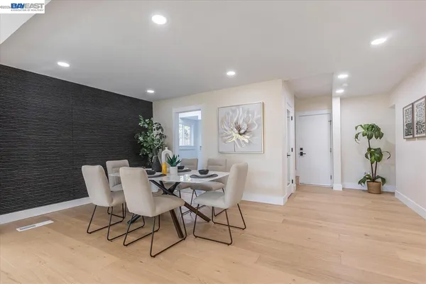 a dining room with furniture and wooden floor