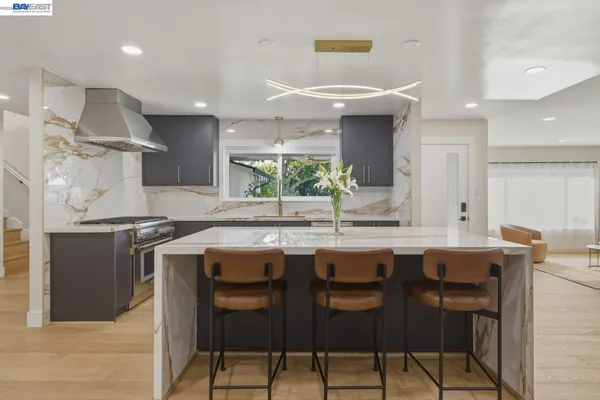 a kitchen with stainless steel appliances a sink and a refrigerator