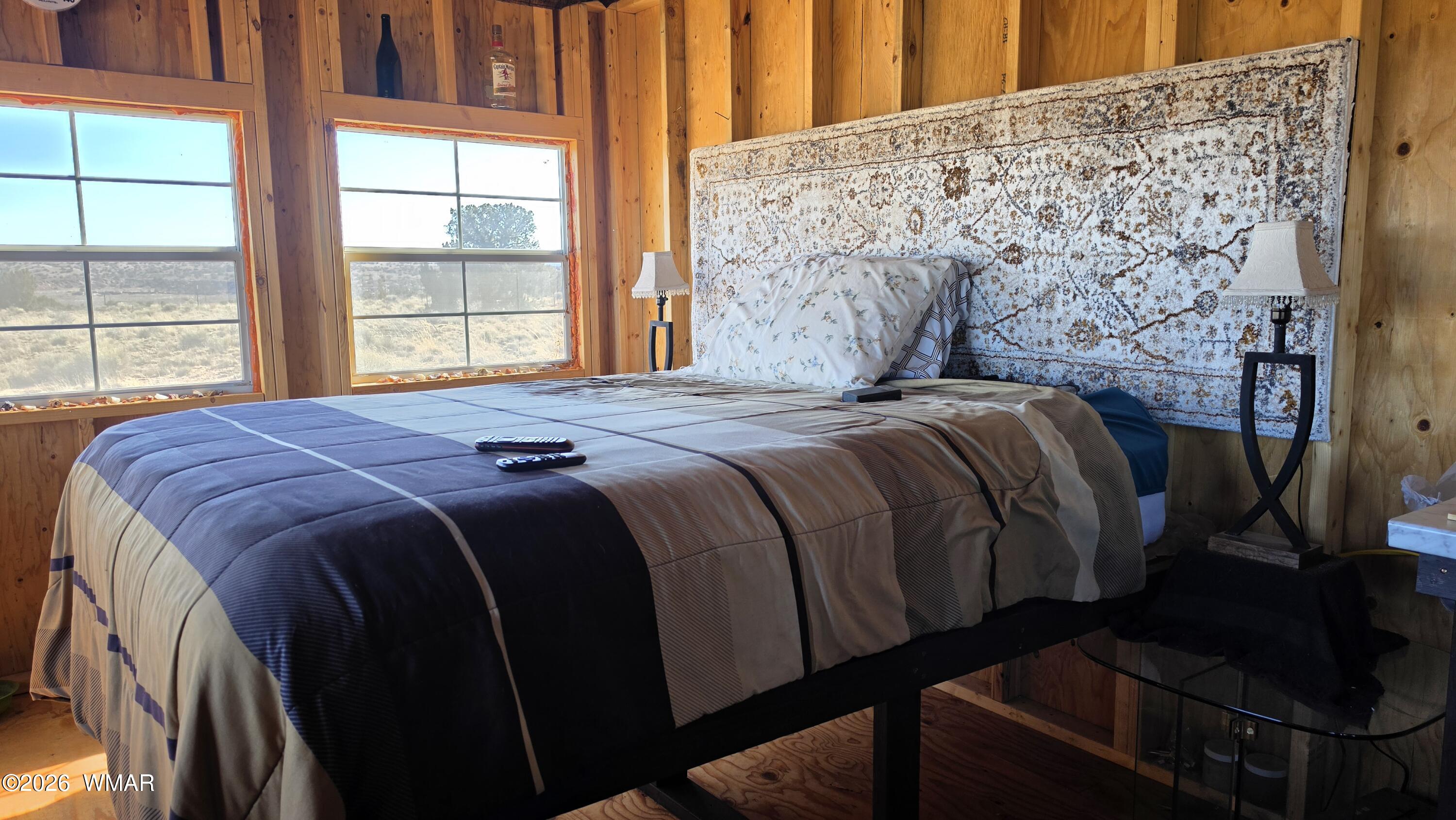 Lot 632 Lazy S Ranch Road Concho, AZ 85924 - Photo 13 of 27 a bed sitting in a bedroom next to a window