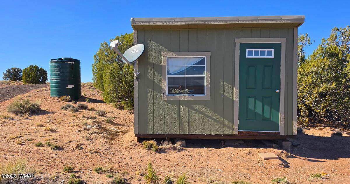 Lot 632 Lazy S Ranch Road Concho, AZ 85924 - Photo 17 of 27 a front view of a house with a yard