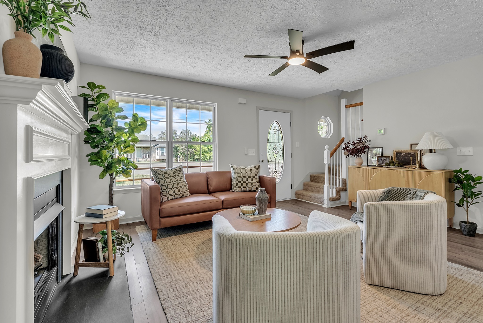 522 Acorn Way Mount Juliet, TN 37122 - Photo 13 of 30 a living room with furniture a fireplace and a potted plant