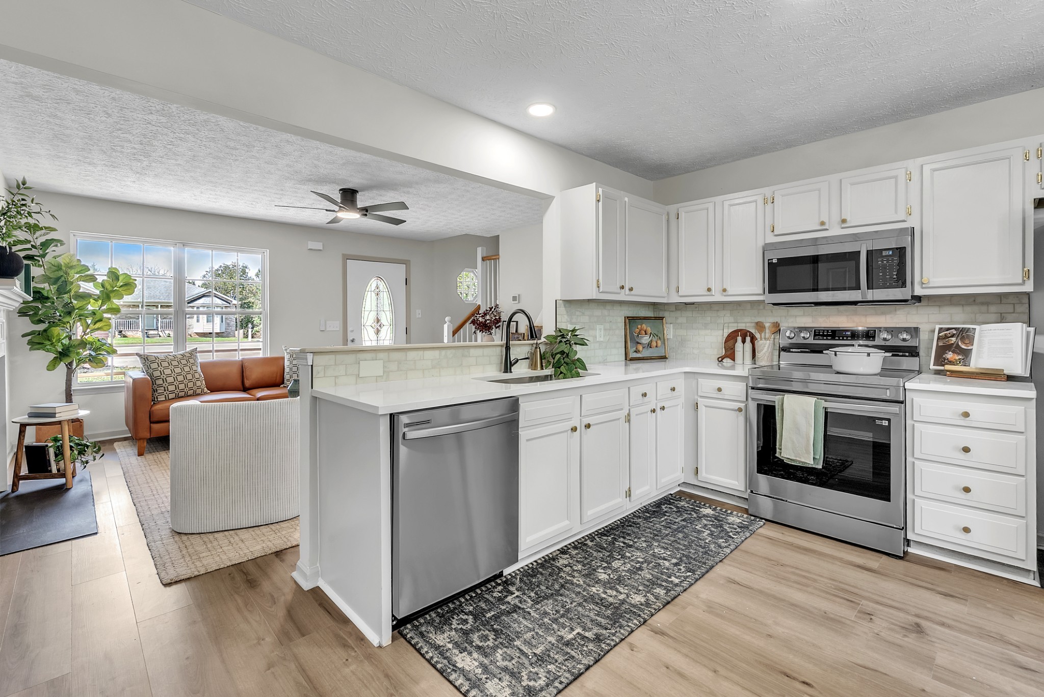 522 Acorn Way Mount Juliet, TN 37122 - Photo 10 of 30 a kitchen with kitchen island granite countertop a sink cabinets and stainless steel appliances