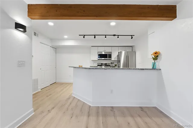 a bedroom with a bed and a wooden floor