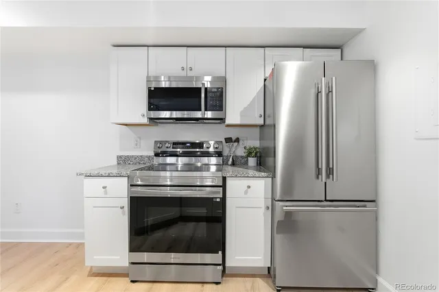 a view of balcony with furniture and a potted plant
