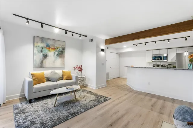 a living room with furniture and kitchen view