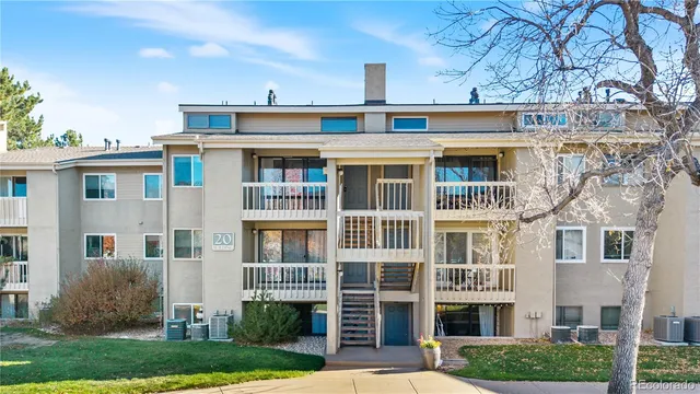 a front view of a building with a garden