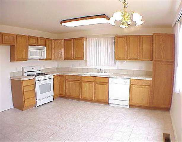 4045 Andrea Street Reno, NV 89503 - Photo 2 of 3 a kitchen with a stove cabinets and window