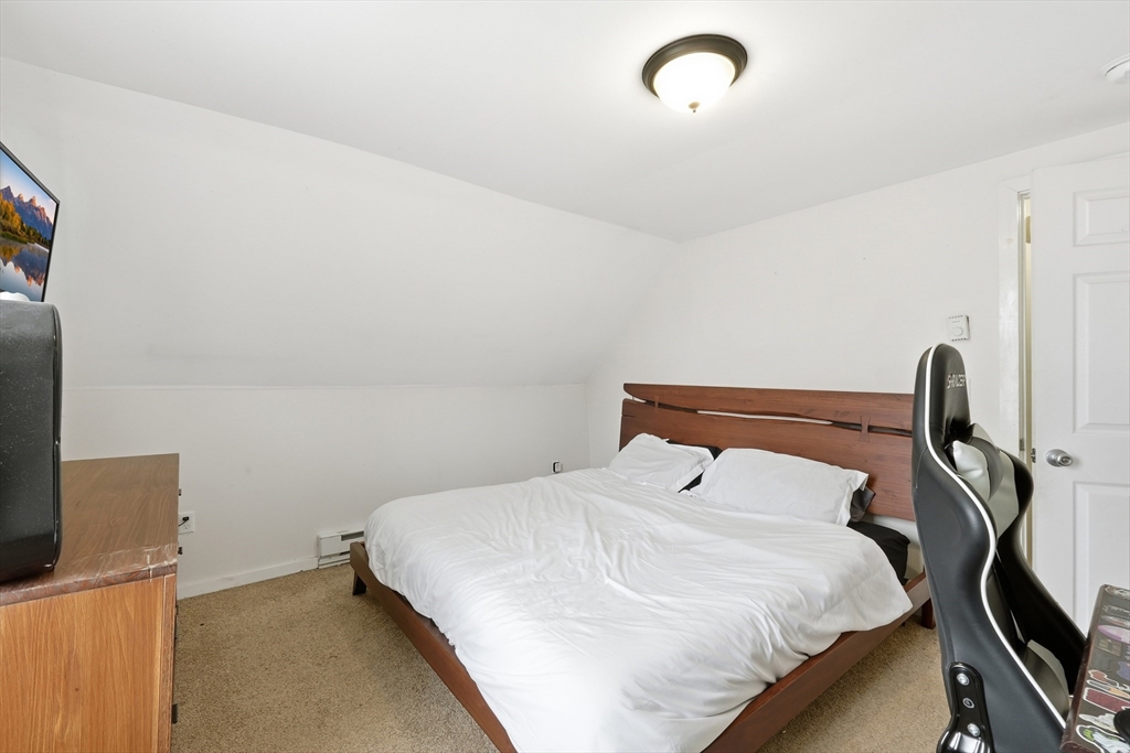 57 Davenport Street Springfield, MA 01119 - Photo 13 of 21 a bedroom with a bed and a flat tv screen on the dresser
