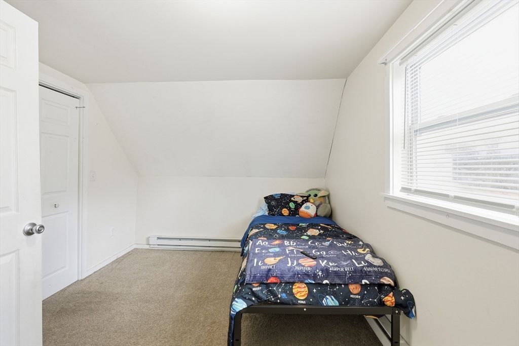 57 Davenport Street Springfield, MA 01119 - Photo 14 of 21 a bedroom with a bed and a window