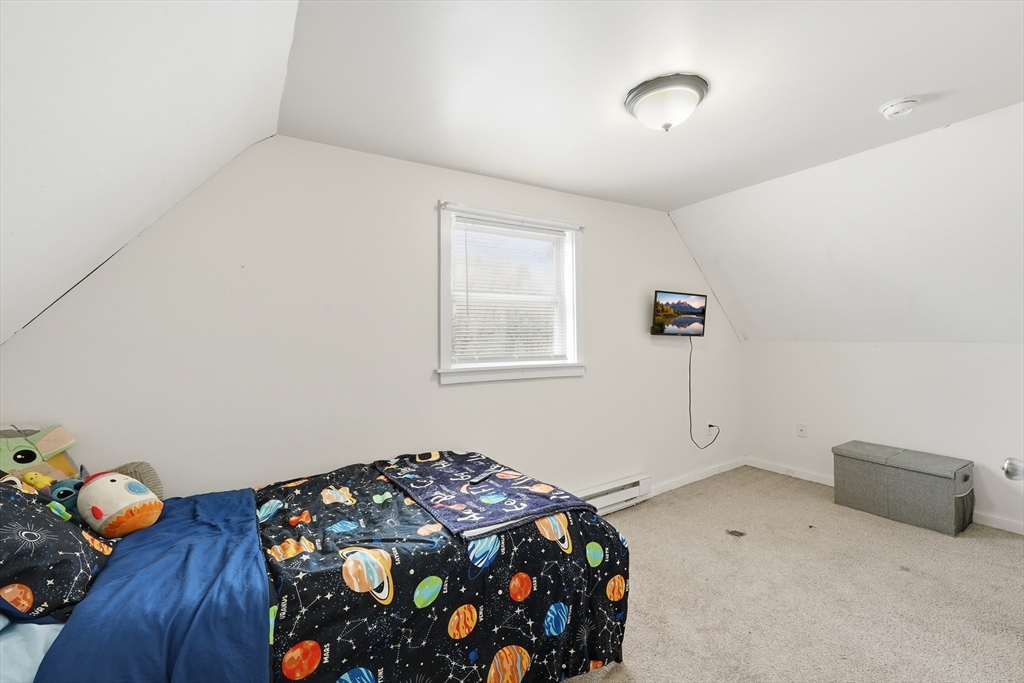 57 Davenport Street Springfield, MA 01119 - Photo 15 of 21 a bedroom with a bed and wooden floor