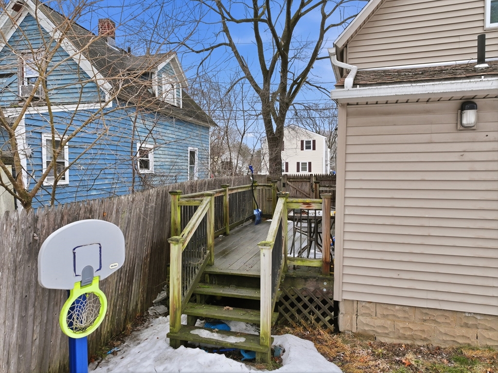 57 Davenport Street Springfield, MA 01119 - Photo 20 of 21 a view of roof deck with wooden fence and a refrigerator