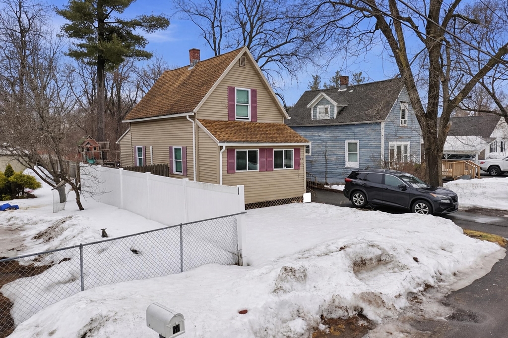 57 Davenport Street Springfield, MA 01119 - Photo 2 of 21 a view of a white house with a yard covered in snow