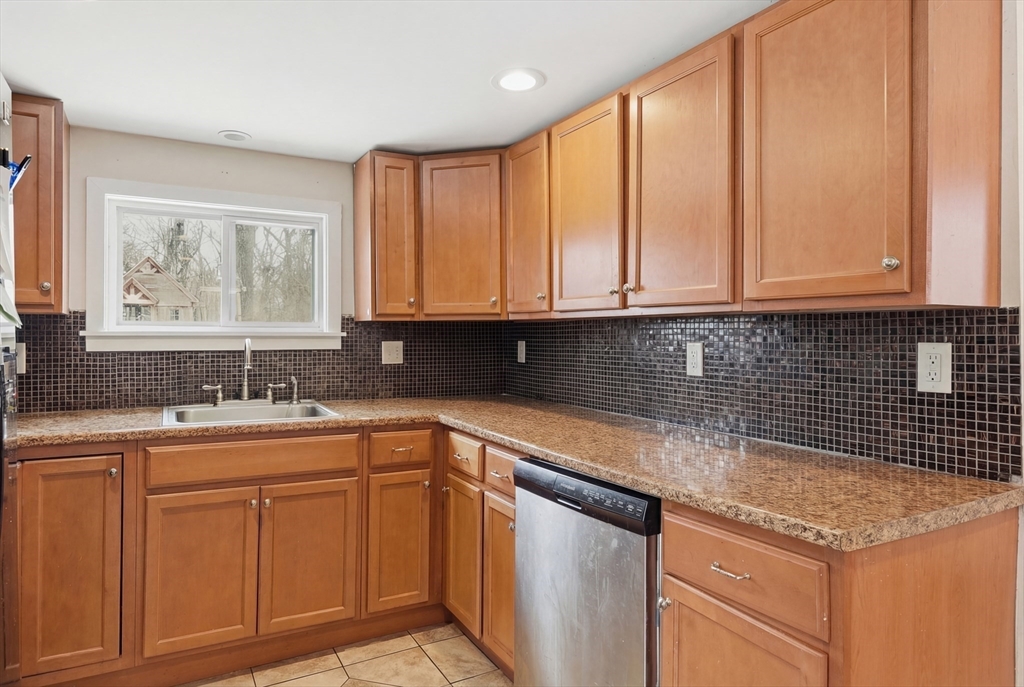 57 Davenport Street Springfield, MA 01119 - Photo 10 of 21 a kitchen with stainless steel appliances granite countertop a sink a stove and cabinets