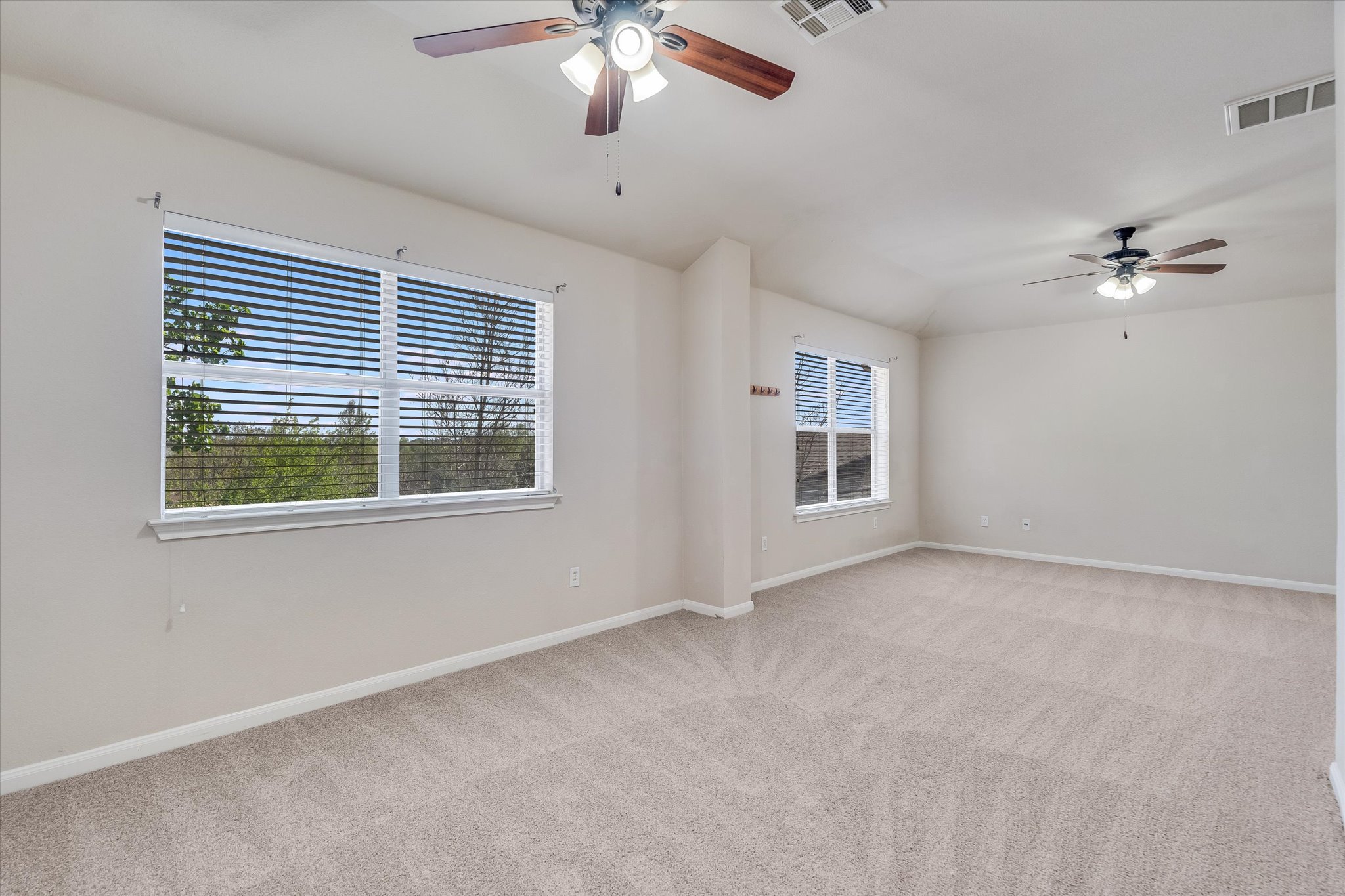 4029 Lake Edge Way Pflugerville, TX 78660 - Photo 12 of 35 Spare room featuring a ceiling fan and light carpet