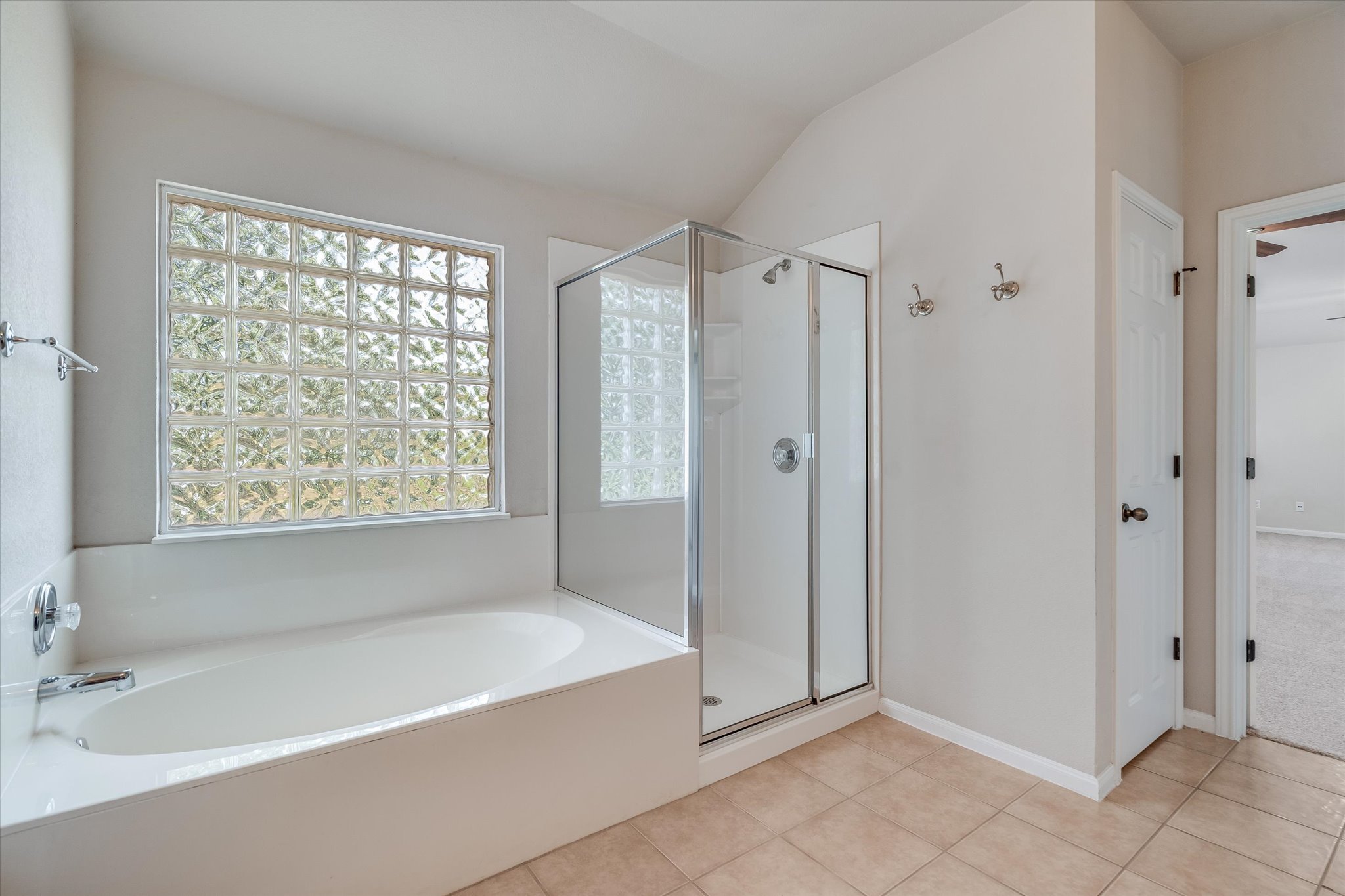 4029 Lake Edge Way Pflugerville, TX 78660 - Photo 15 of 35 Full bathroom with a stall shower, a bath, light tile patterned flooring, and lofted ceiling