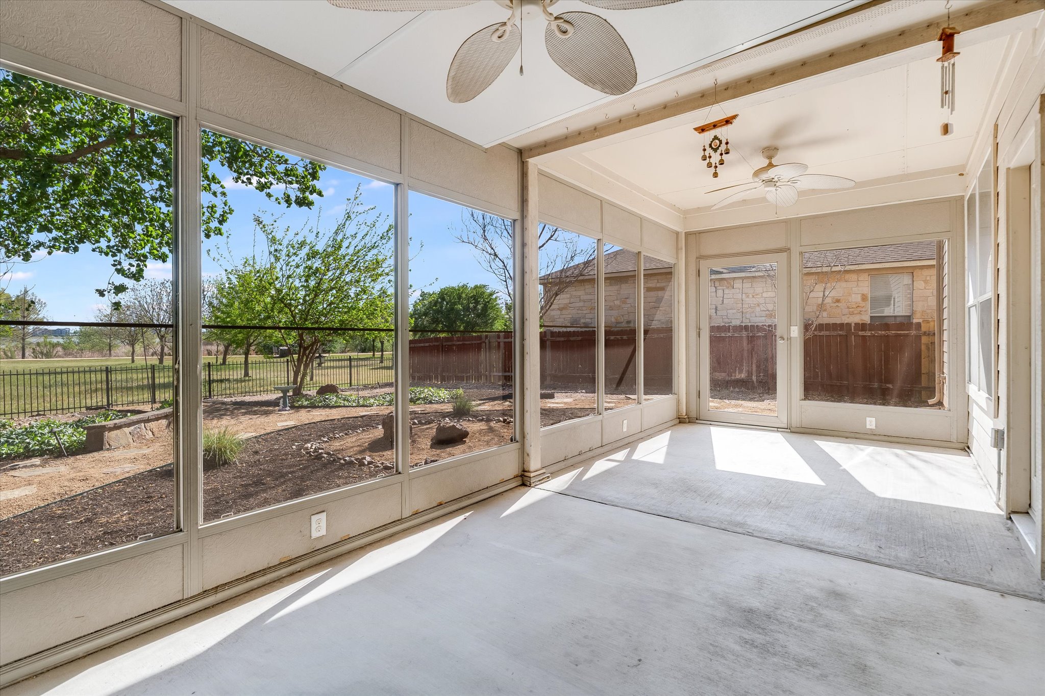 4029 Lake Edge Way Pflugerville, TX 78660 - Photo 20 of 35 a view of a porch with a floor to ceiling window and a room
