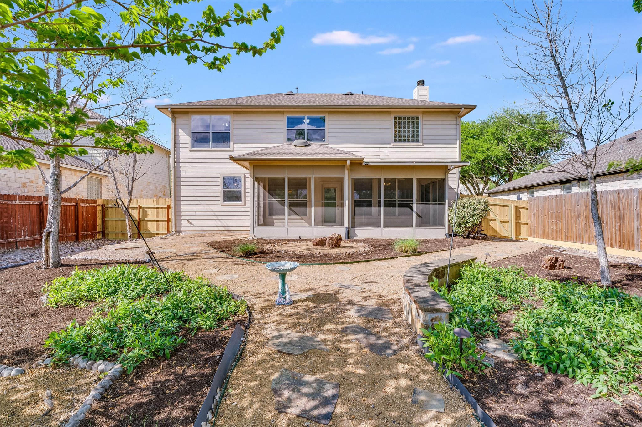 4029 Lake Edge Way Pflugerville, TX 78660 - Photo 21 of 35 Back of house featuring a sunroom, a chimney, a fenced backyard, and a gate