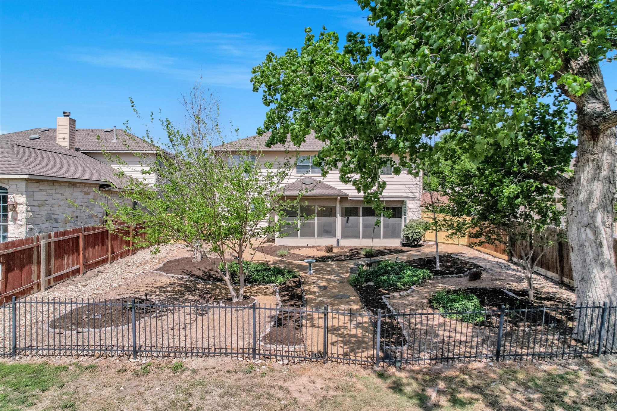 4029 Lake Edge Way Pflugerville, TX 78660 - Photo 25 of 35 Rear view of house featuring a sunroom, a fenced backyard, and a shingled roof
