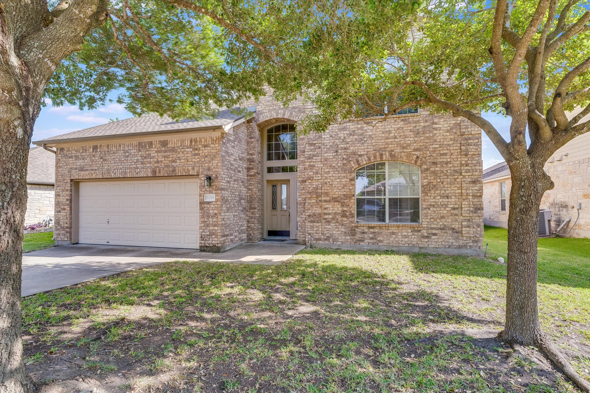 4029 Lake Edge Way Pflugerville, TX 78660 - Photo 3 of 35 a front view of a house with a yard and garage