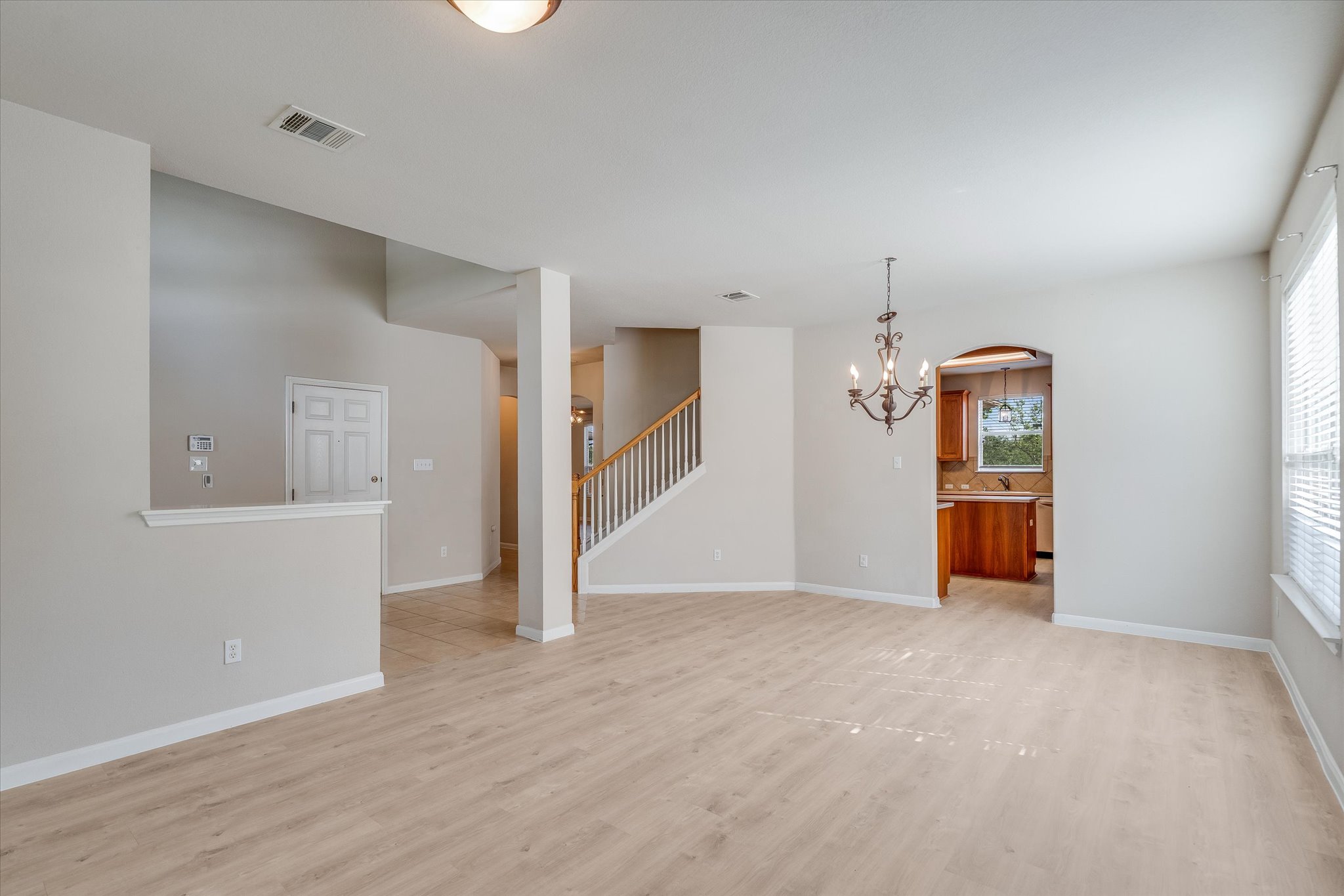 4029 Lake Edge Way Pflugerville, TX 78660 - Photo 6 of 35 wooden floor in an empty room with a window