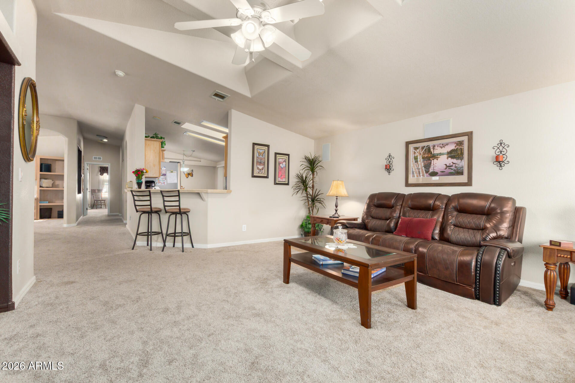 3301 South Goldfield Road, Unit 4086 Apache Junction, AZ 85119 - Photo 16 of 41 a living room with furniture and a chandelier