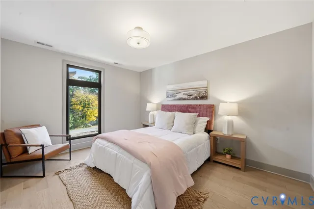 a bathroom with a granite countertop sink a mirror and a toilet