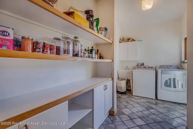 a utility room with cabinets washer and dryer