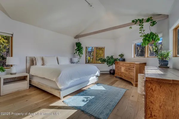a bedroom with a large bed and a couch